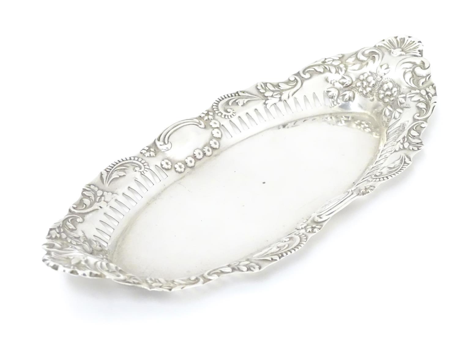 A silver dish of oval form with pierced and embossed decoration , hallmarked Birmingham 1899 maker - Image 3 of 6