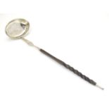 A Scottish silver punch ladle with twist handle. 13 1/2" Please Note - we do not make reference to