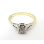 An 18ct gold diamond solitaire ring in a square setting. Ring size approx O Please Note - we do