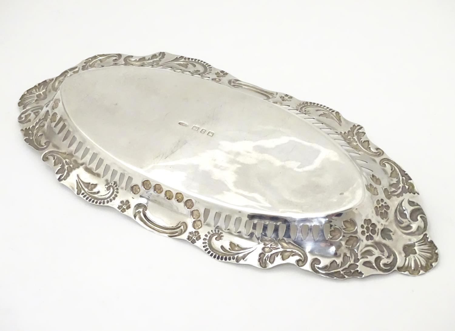 A silver dish of oval form with pierced and embossed decoration , hallmarked Birmingham 1899 maker - Image 6 of 6