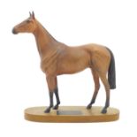 A Beswick matte equestrian model of the horse Red Rum on an oval base. Marked under and titled to