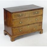 An 18thC walnut chest of drawers with a feather banded top above three long drawers with crossbanded