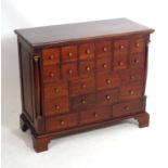 A late 20thC mahogany apothecary cabinet with a moulded rectangular top above twenty-three short