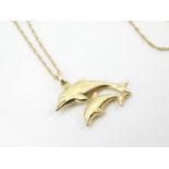 A 9ct double dolphin pendant on a gold chain 16" long Please Note - we do not make reference to