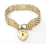 A 9ct gold bracelet with padlock clasp . Approx 7 1/2" long x 1/2" wide (approx 16g) Please Note -