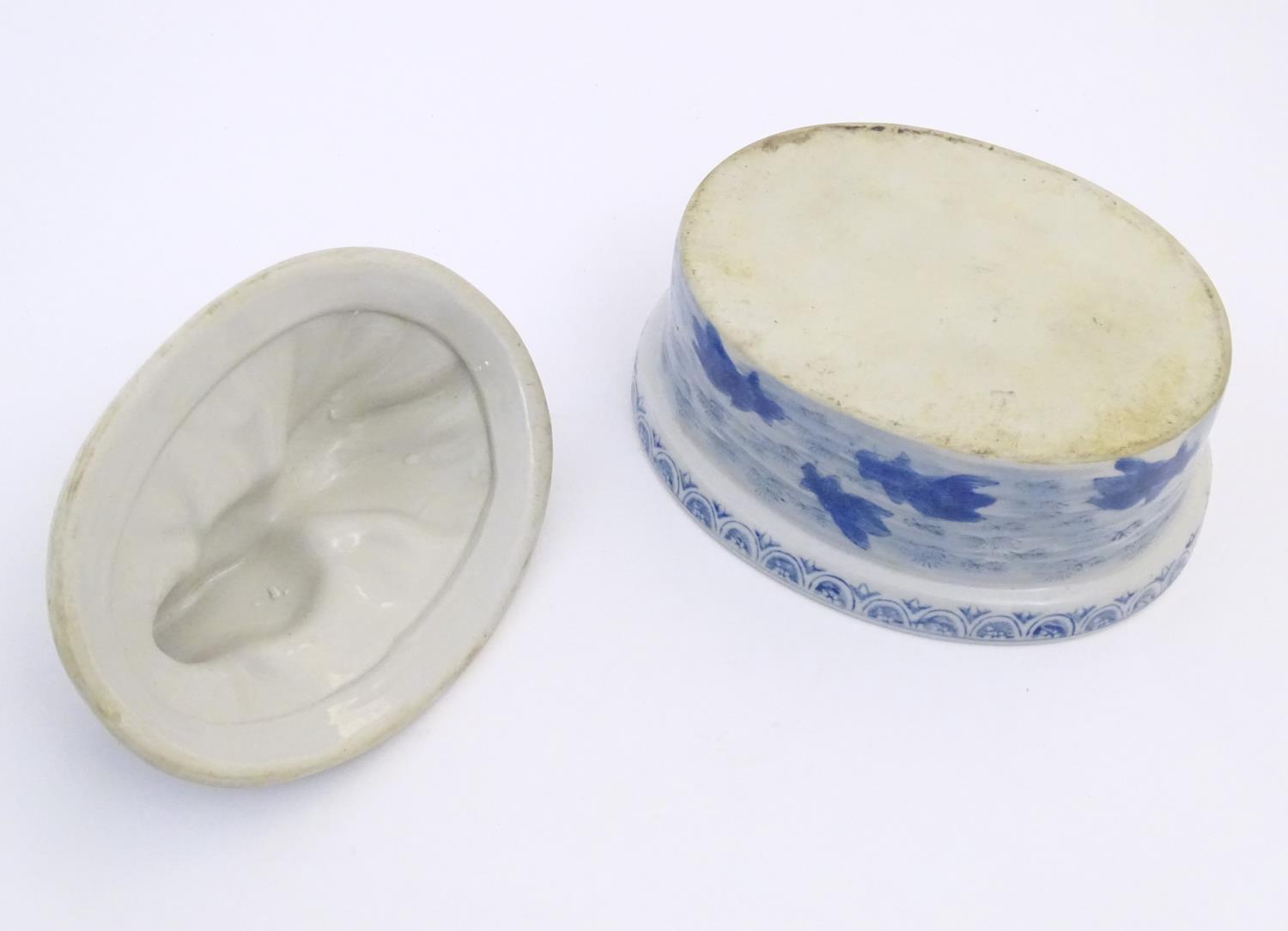 A Chinese blue and white dish and cover of oval form, the lid surmounted by a fish in relief, the - Image 2 of 6