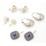 Four assorted pairs of silver and white metal earrings. Please Note - we do not make reference to