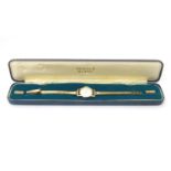 A mid 20thC Vertex Revue 9ct gold ladies' watch, cased, the face measuring 3/4", with 9ct gold strap