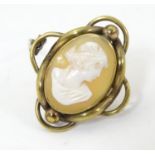 A gilt metal brooch set with shell carved cameo to centre 1 1/4" high Please Note - we do not make