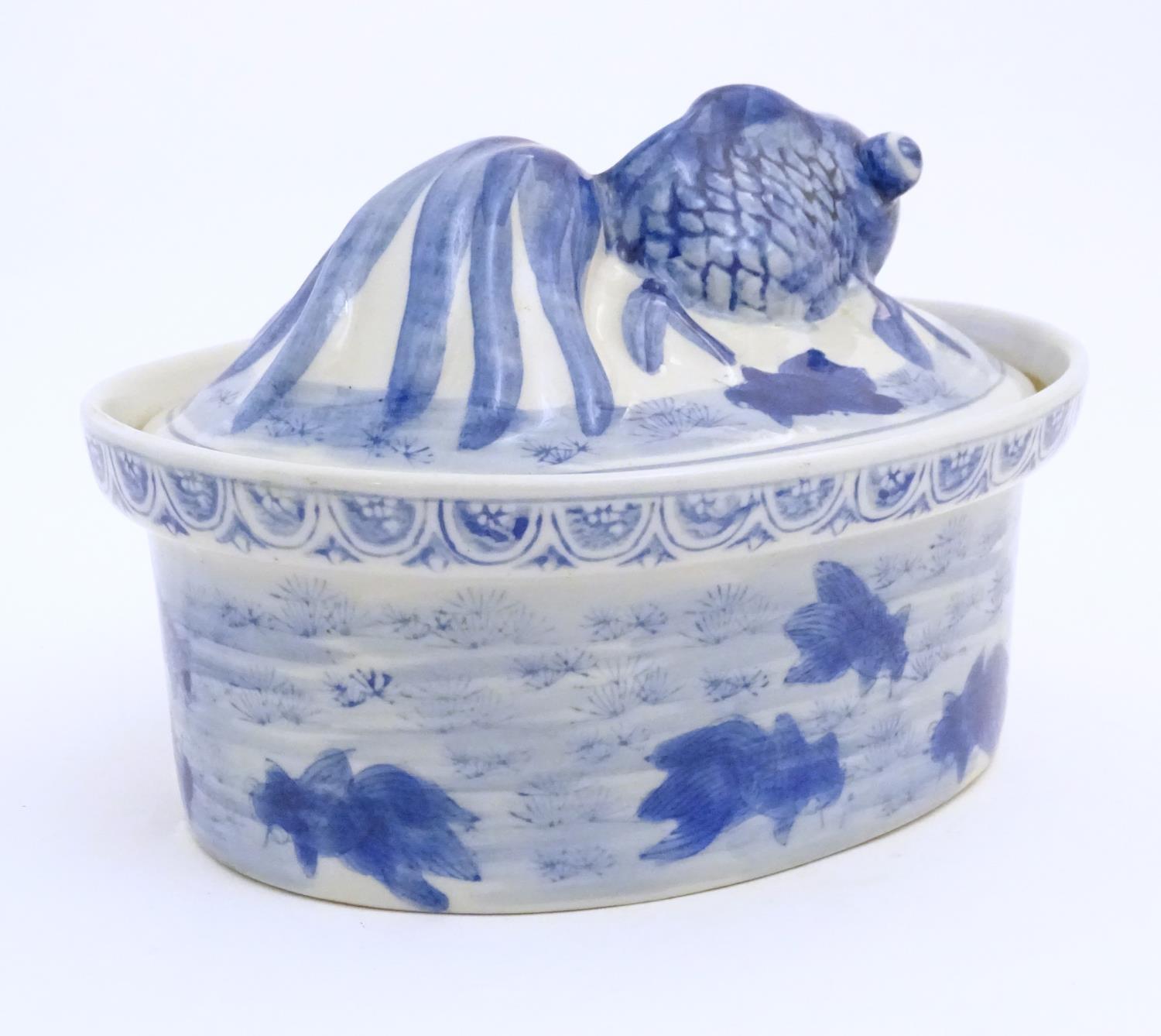 A Chinese blue and white dish and cover of oval form, the lid surmounted by a fish in relief, the - Image 5 of 6