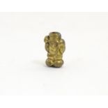 A Japanese brass ojime bead formed as a laughing figure. Approx. 5/8" Please Note - we do not make