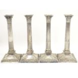 A set of 4 silver plate Corinthian column candlesticks with acanthus detail . Approx 11" high Please