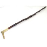 A blackthorn walking stick, with vine twist shank, fruitwood collar, brass ferrule and antler