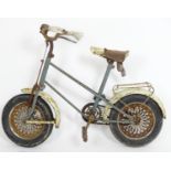 An early 20thC small bicycle / bike with a covered seat and handlebars. The frame with blue