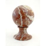 A large marble sphere on marble stand. The whole standing approx. 9 1/2" high