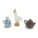 Three Chinese ceramic items comprising a Yixing clay teapot, a blue and white water pot and a