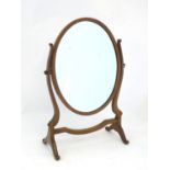 An early / mid 20thC mahogany dressing table mirror with an oval surround and shaped frame. 16" wide