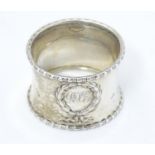 A silver napkin ring with laurel chaplet decoration hallmarked Birmingham 1923, maker Docker and