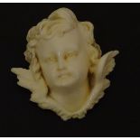 A Victorian carved ivory head of an angel, in the manner of Raphael's angels. Approx. 1 3/4" wide