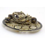 An Oriental soapstone teapot, tray and cups. The oval tray with carved openwork detail depicting