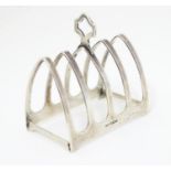 A silver toast rack with 5 arched bars and central handle. Hallmarked Sheffield 1933 maker Viner's