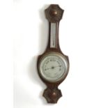A 20thC aneroid wheel barometer Approx 26" long Please Note - we do not make reference to the