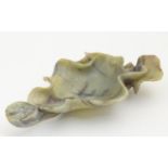 An Oriental carved soapstone brush washer dish formed as a stylised lotus leaf and pod. Approx. 5