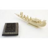 A 19thC Indian carved ivory model of a wedding barge with 7 figures, the boat with bird and beast