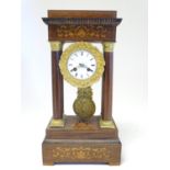 An Empire style four pillar clock, with gilt metal mounts and inlaid detail Approx 18 1/2" high