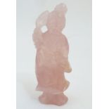 A Chinese carved rose quartz model of a female figure with a flower, possibly Guan Yin. Approx. 5