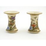 A pair of Japanese miniature Satsuma vases with flared rims and bases, decorated with flowers and