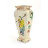 An Oriental vase with twin handles of elephant head form. The body with hand painted figures and