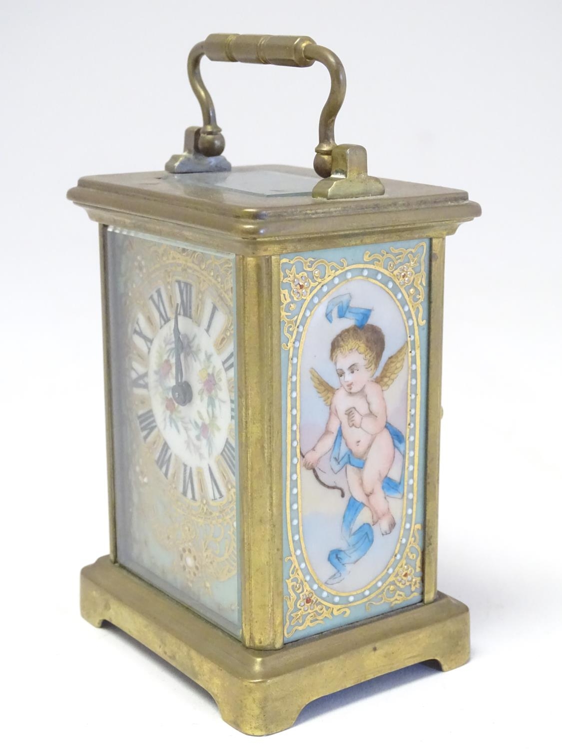 A French Carriage clock with hand painted porcelain panels. Approx 6" high Please Note - we do not