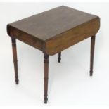 A mid 19thC mahogany pembroke table with drop flaps to each side and having a single short drawer