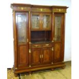 A large continental mahogany cabinet with a moulded cornice above gilt metal mounts and glazed doors