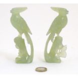 A pair of Oriental carved jade / hardstone models of birds among foliate. Approx. 4 3/4" high (2)