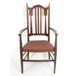 An early 20thC mahogany Arts & Crafts chair with a shaped, slatted backrest and marquetry inlay. 21"