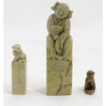 Two Chinese carved soapstone hand seals, on topped with a figure with a fan, the other with a foo