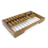 Toy: A 20thC Russian abacus. Approx. 10 1/4" x 18" Please Note - we do not make reference to the