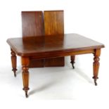 A late 19thC mahogany dining table, having a moulded edge above four turned tapering legs with