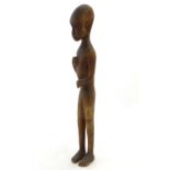 Ethnographic / Native / Tribal: A carved Kenyan statue of a male figure. Approx. 17" high Please