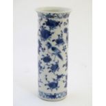 An Oriental blue and white vase of cylindrical form decorated with birds, flowers and foliage.