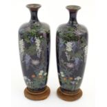 A pair of Japanese enamel cloisonne vases of ovoid form with flower detail to include wisteria ,