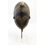 Ethnographic / Native / Tribal: A carved African mask on stand. The whole approx. 17 1/2" high