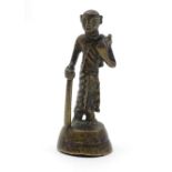 An Oriental brass figure modelled as a man with a staff. Approx. 4 1/2" high Please Note - we do not