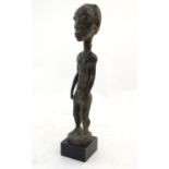 Ethnographic / Native / Tribal: A carved Ivory Coast statue with carved detail. Approx. 17 1/2" high