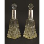 A pair of cut glass perfume / scent bottles of with silver collars hallmarked Birmingham 1920/21.