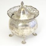 A silver pot with fret work detail and hinged lid. Hallmarked Chester 1910 maker George Nathan &