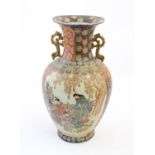 A large Japanese Satsuma vase with scrolling twin handles, the body decorated with Geisha style
