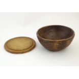 A 19thC treen carved wooden fruit bowl, together with a bread board of circular form. Bowl approx. 4